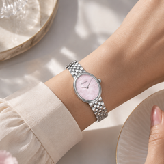Pink oval women’s watch worn on the wrist